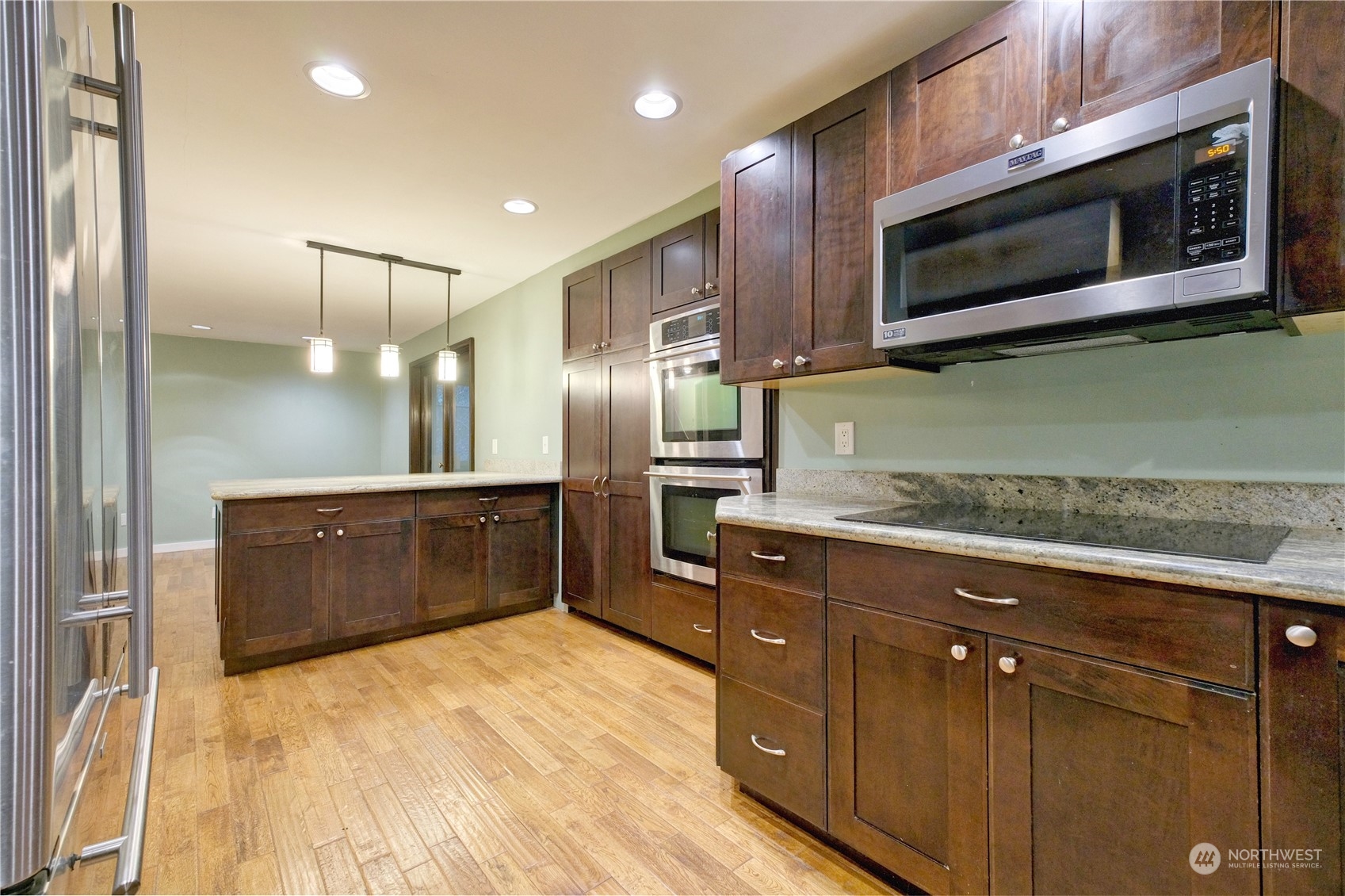 17802 Southeast Jones Road Renton, WA 98058 - Photo 6 of 38 a kitchen with stainless steel appliances granite countertop a stove a microwave and a refrigerator