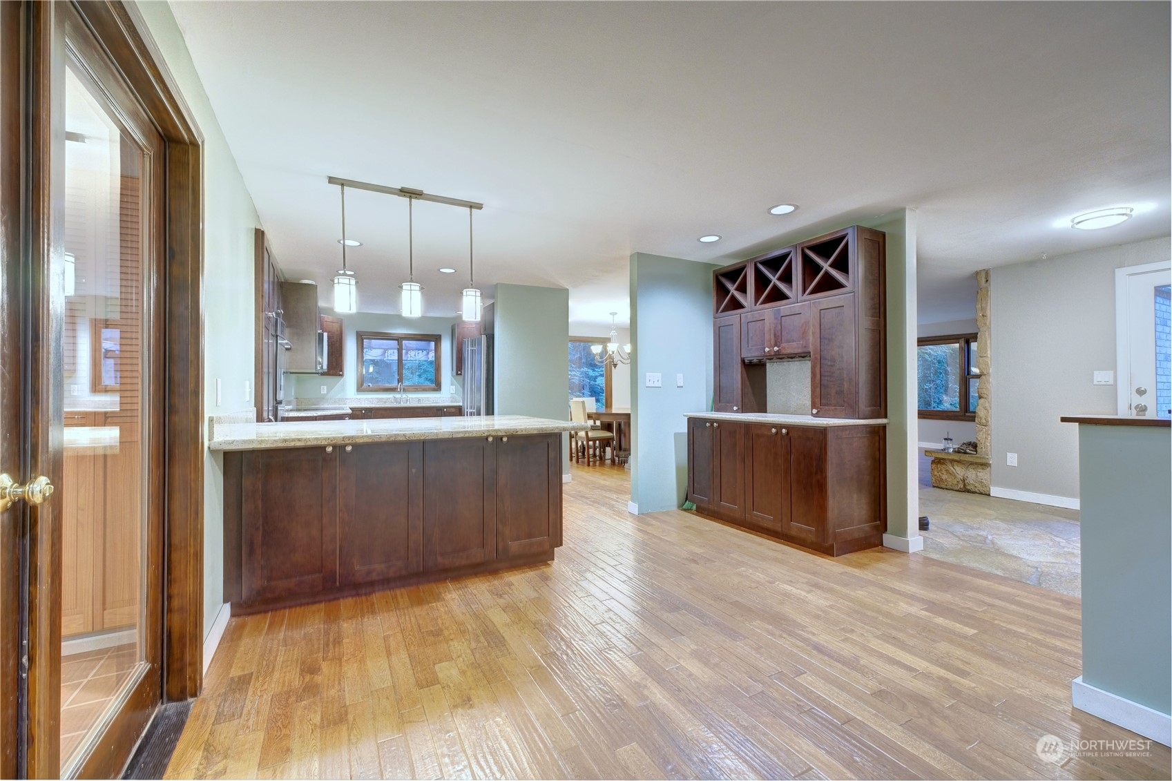 17802 Southeast Jones Road Renton, WA 98058 - Photo 8 of 38 a kitchen with stainless steel appliances kitchen island wooden floors and refrigerator