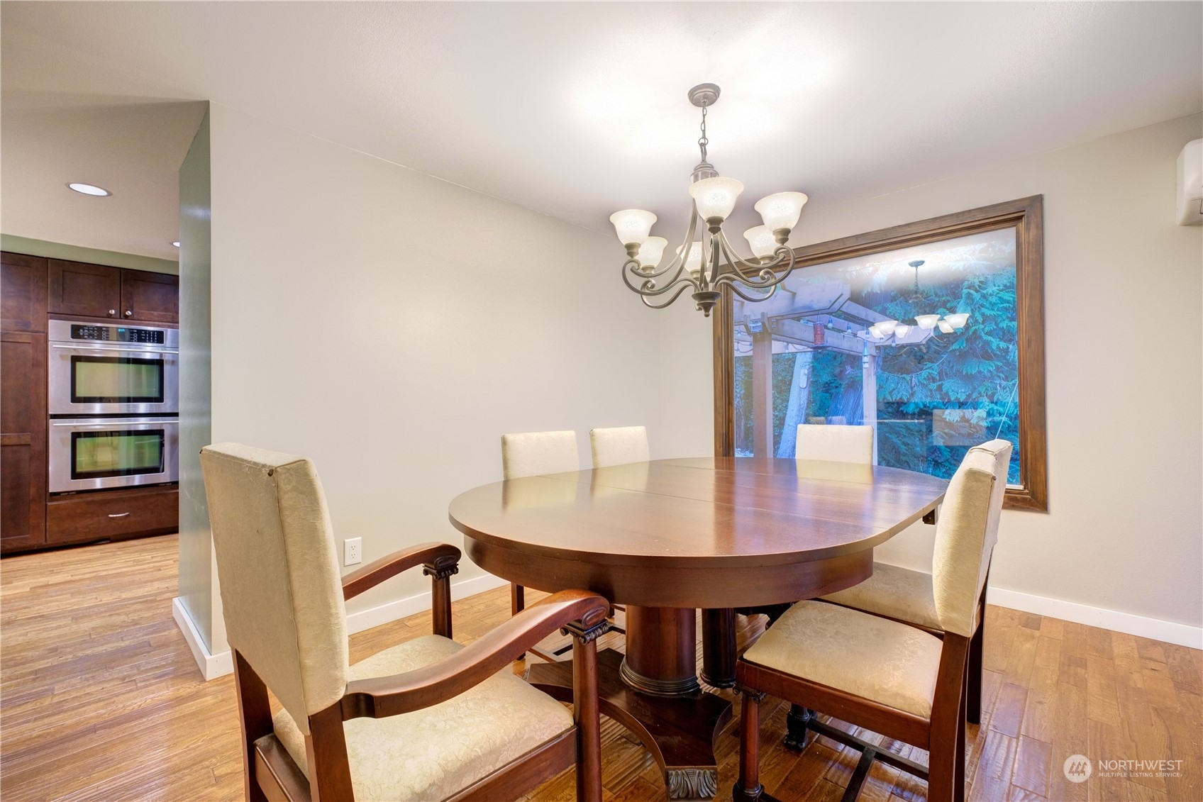 17802 Southeast Jones Road Renton, WA 98058 - Photo 10 of 38 a view of a dining room with furniture wooden floor and chandelier