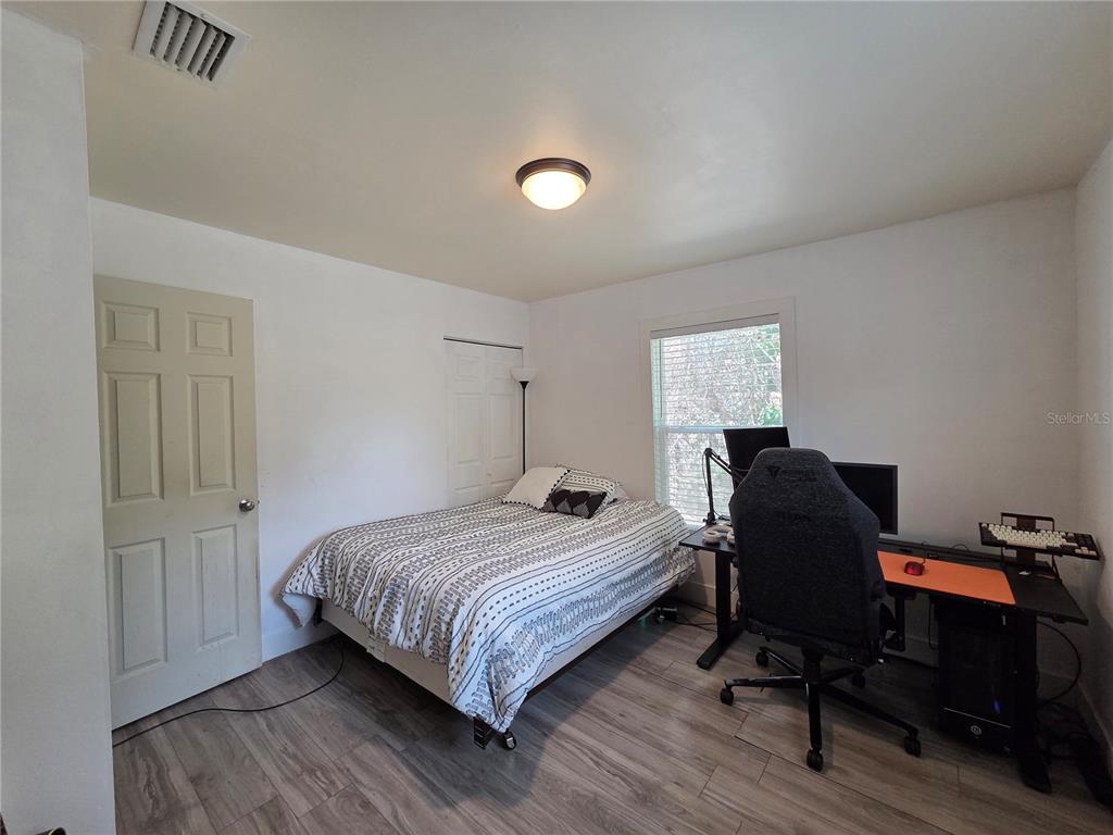 124 East F Street Frostproof, FL 33843 - Photo 19 of 37 a bedroom with a bed and a desk