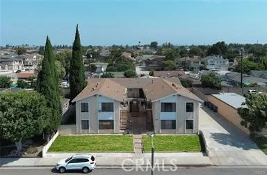a aerial view of a house next to a big yard and large trees
