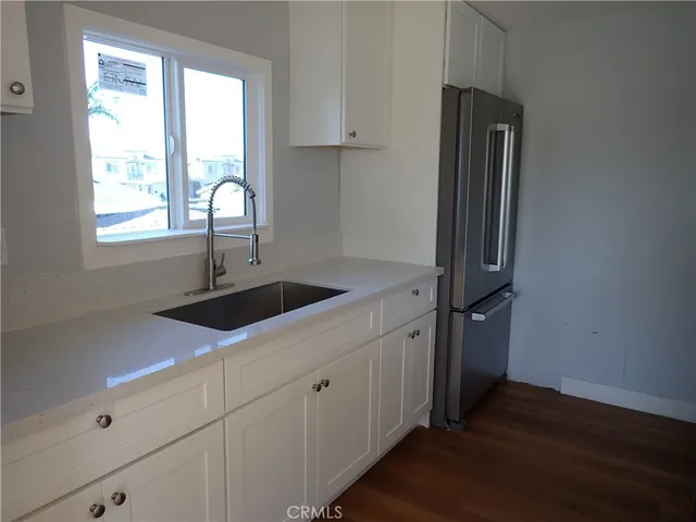 a kitchen with a sink cabinets and window