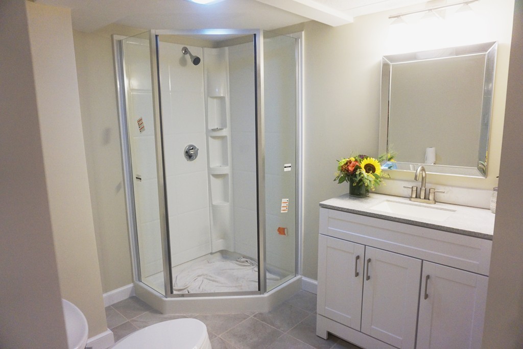115 Harvard Road Littleton, MA 01460 - Photo 12 of 20 a bathroom with a granite countertop sink a toilet and shower