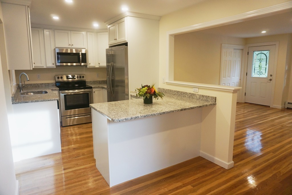 115 Harvard Road Littleton, MA 01460 - Photo 4 of 20 a kitchen with stainless steel appliances granite countertop a sink stove and refrigerator