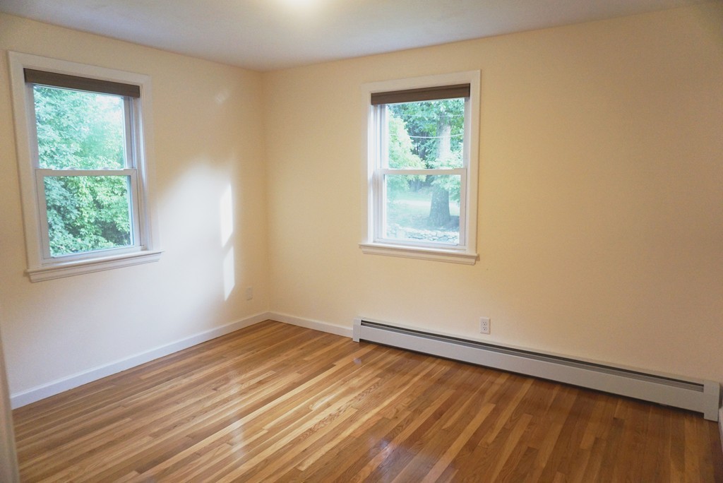 115 Harvard Road Littleton, MA 01460 - Photo 9 of 20 a view of an empty room with wooden floor and a window