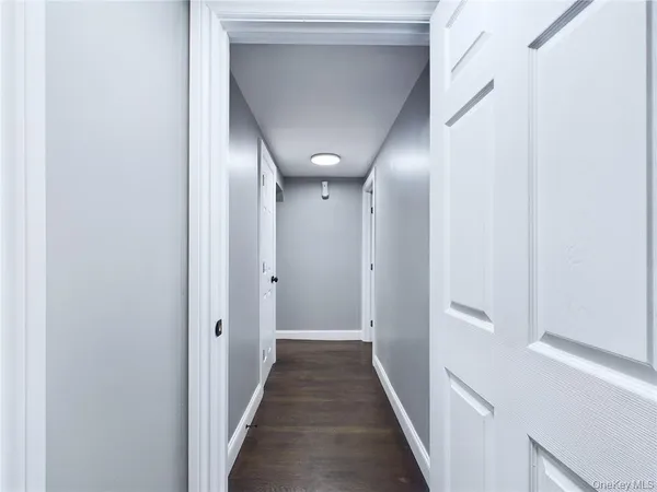 a view of a hallway with wooden floor