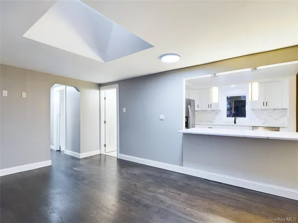 a view of a kitchen with wooden floor and a sink