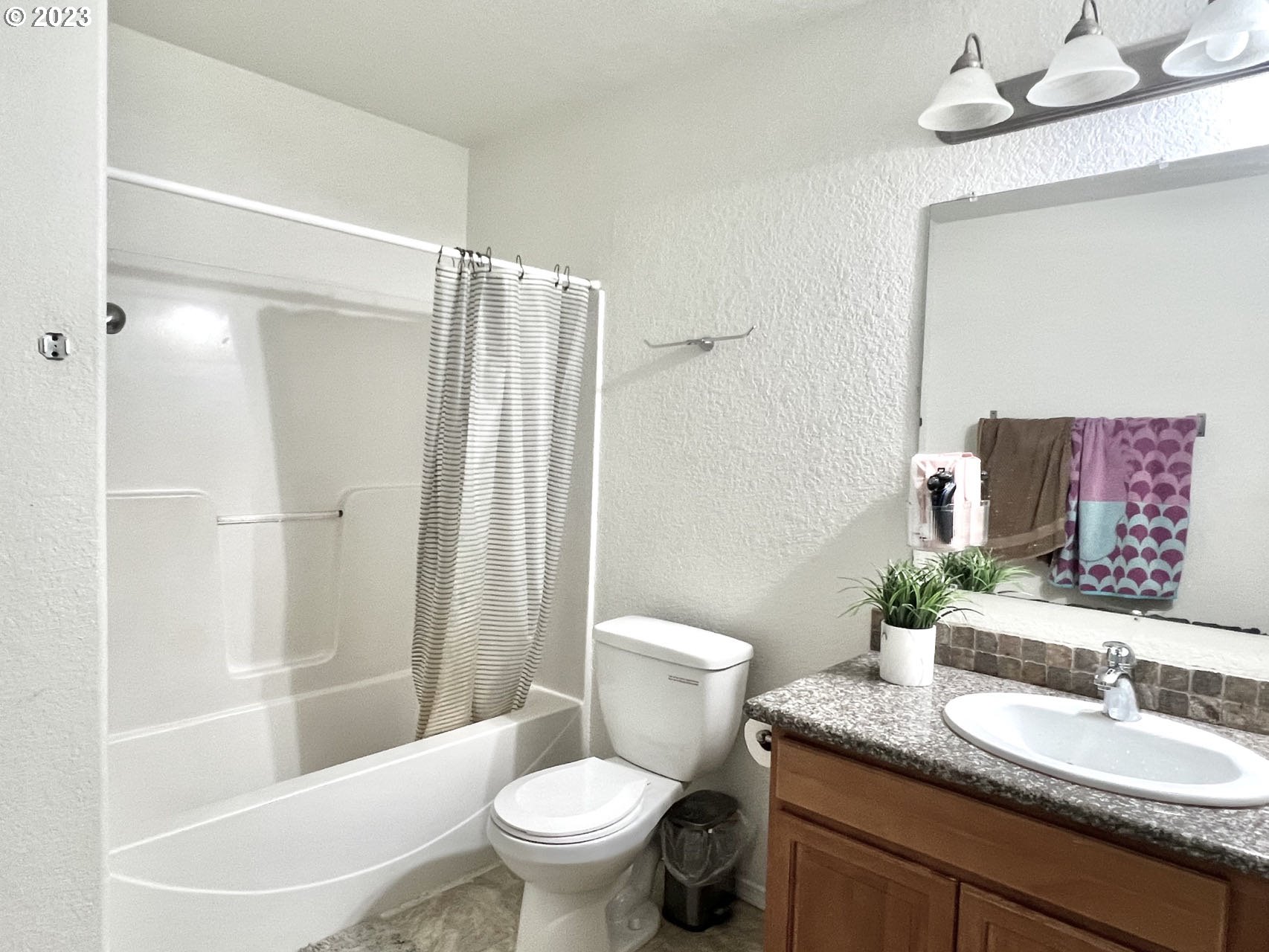 12428 Southeast Center Street Portland, OR 97236 - Photo 11 of 17 a bathroom with a granite countertop sink toilet and shower