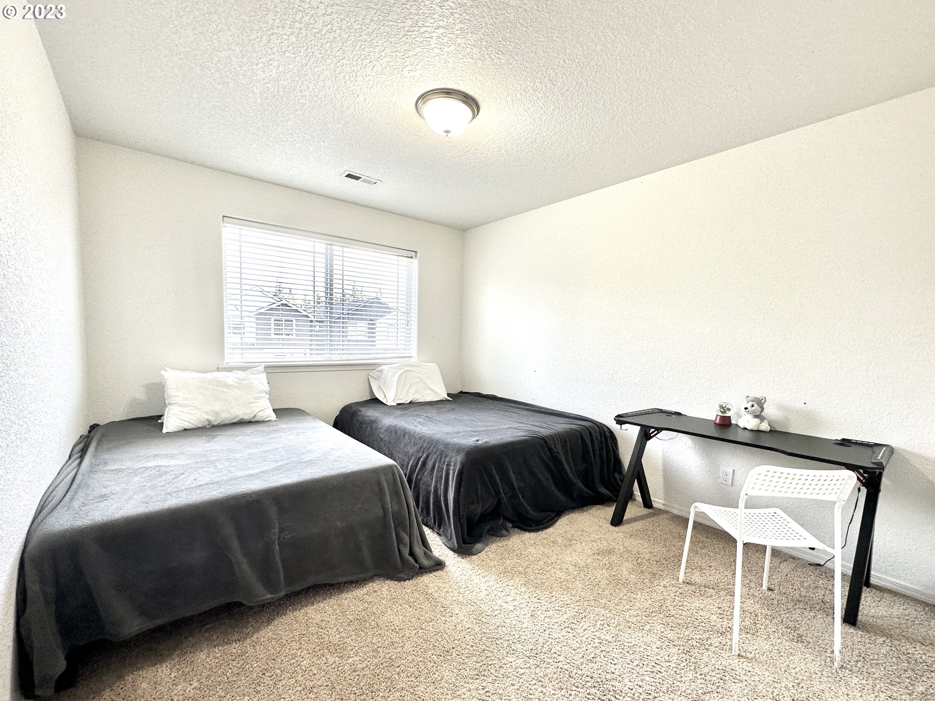 12428 Southeast Center Street Portland, OR 97236 - Photo 13 of 17 a bedroom with a bed and a chair