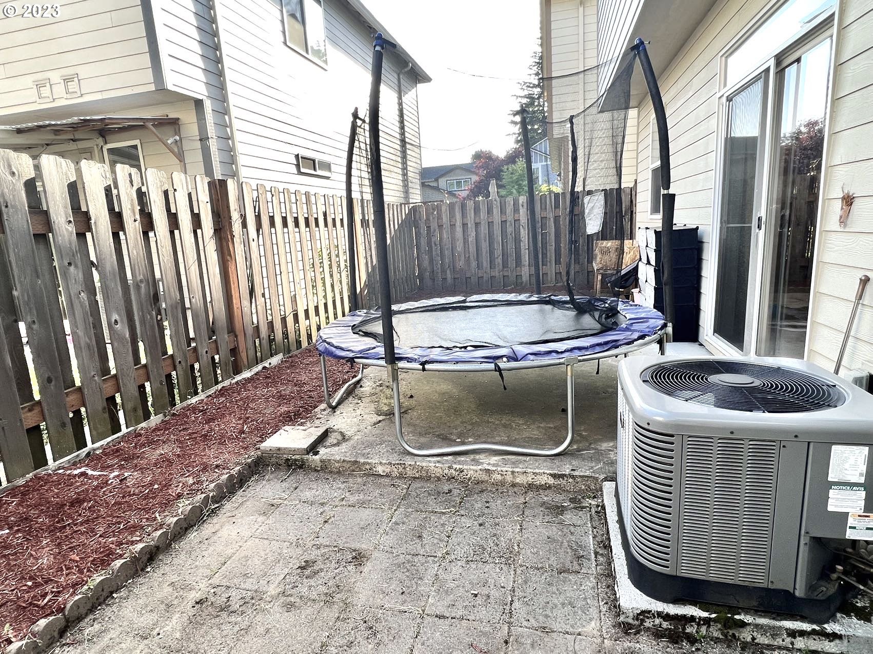 12428 Southeast Center Street Portland, OR 97236 - Photo 17 of 17 a patio with table and chairs
