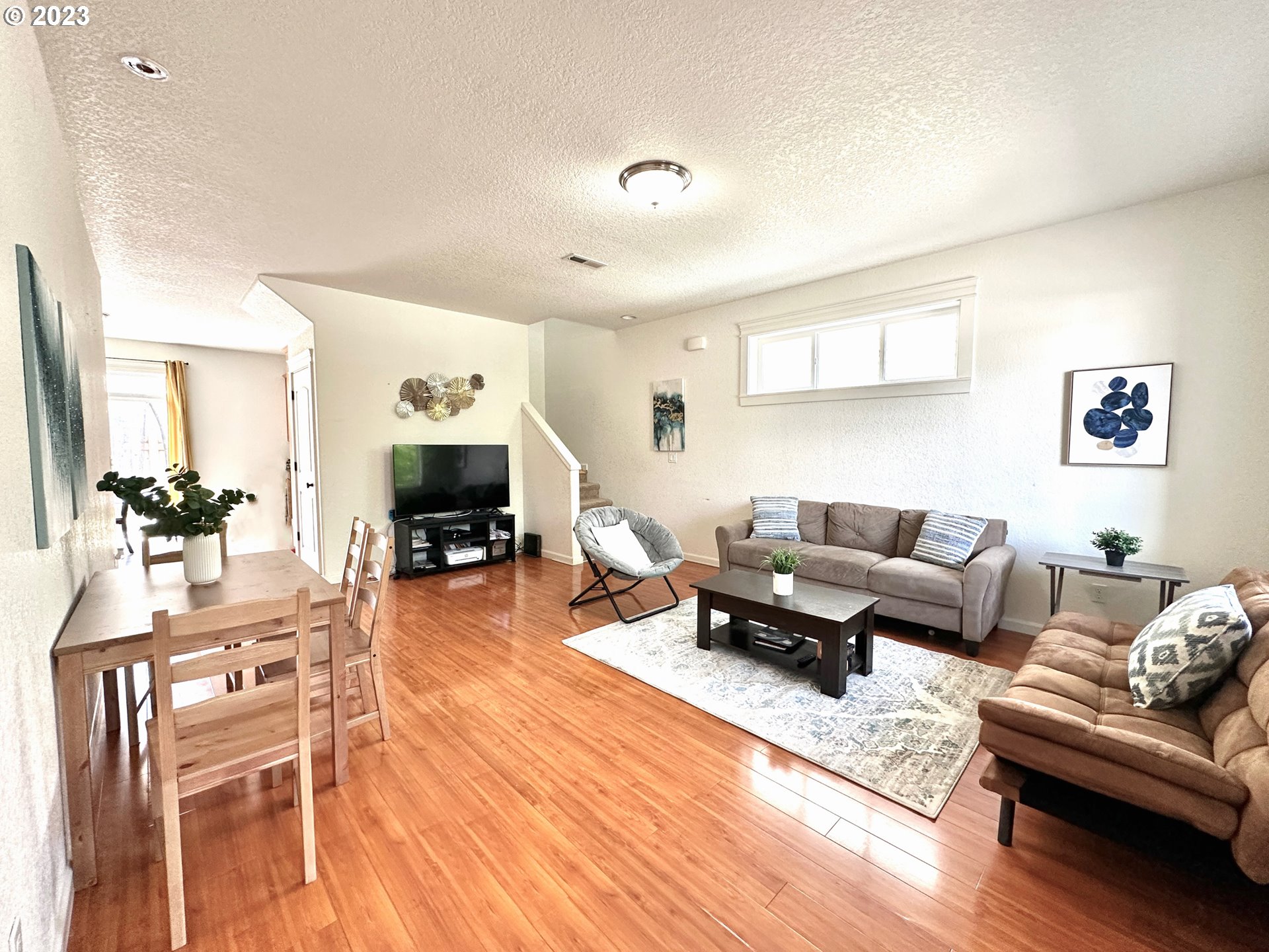 12428 Southeast Center Street Portland, OR 97236 - Photo 2 of 17 a living room with furniture and a fireplace