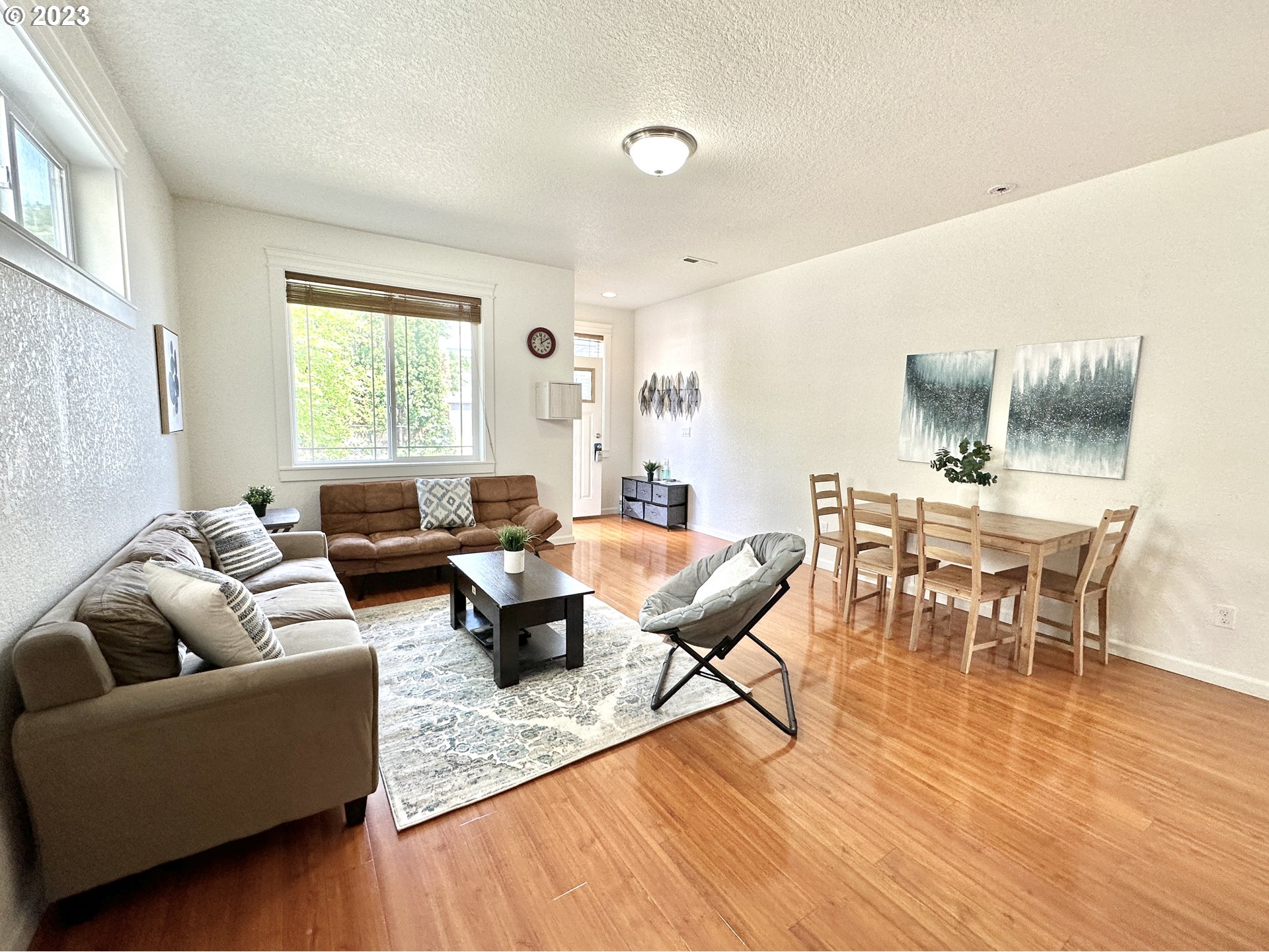 12428 Southeast Center Street Portland, OR 97236 - Photo 3 of 17 a living room with furniture and a wooden floor