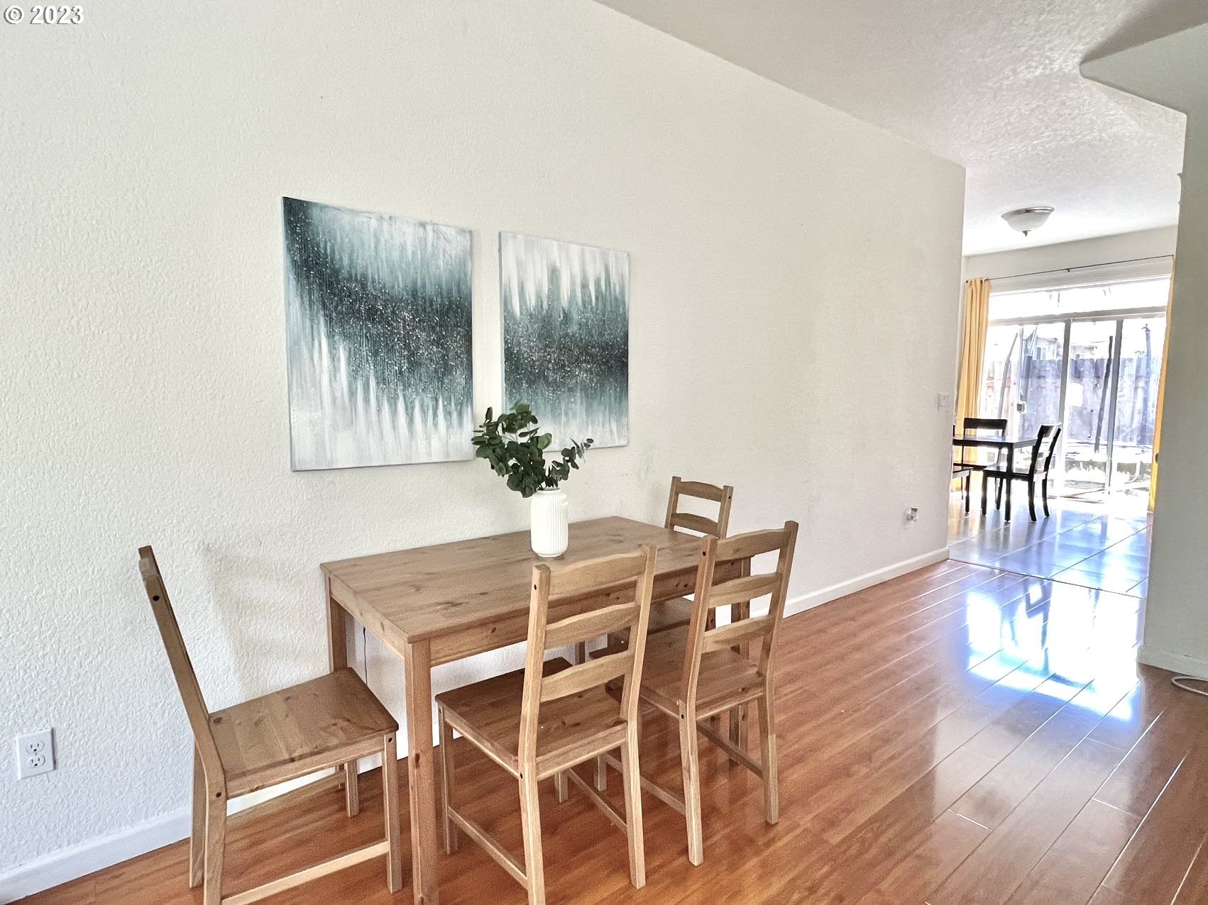 12428 Southeast Center Street Portland, OR 97236 - Photo 5 of 17 a view of a dining room with furniture and wooden floor