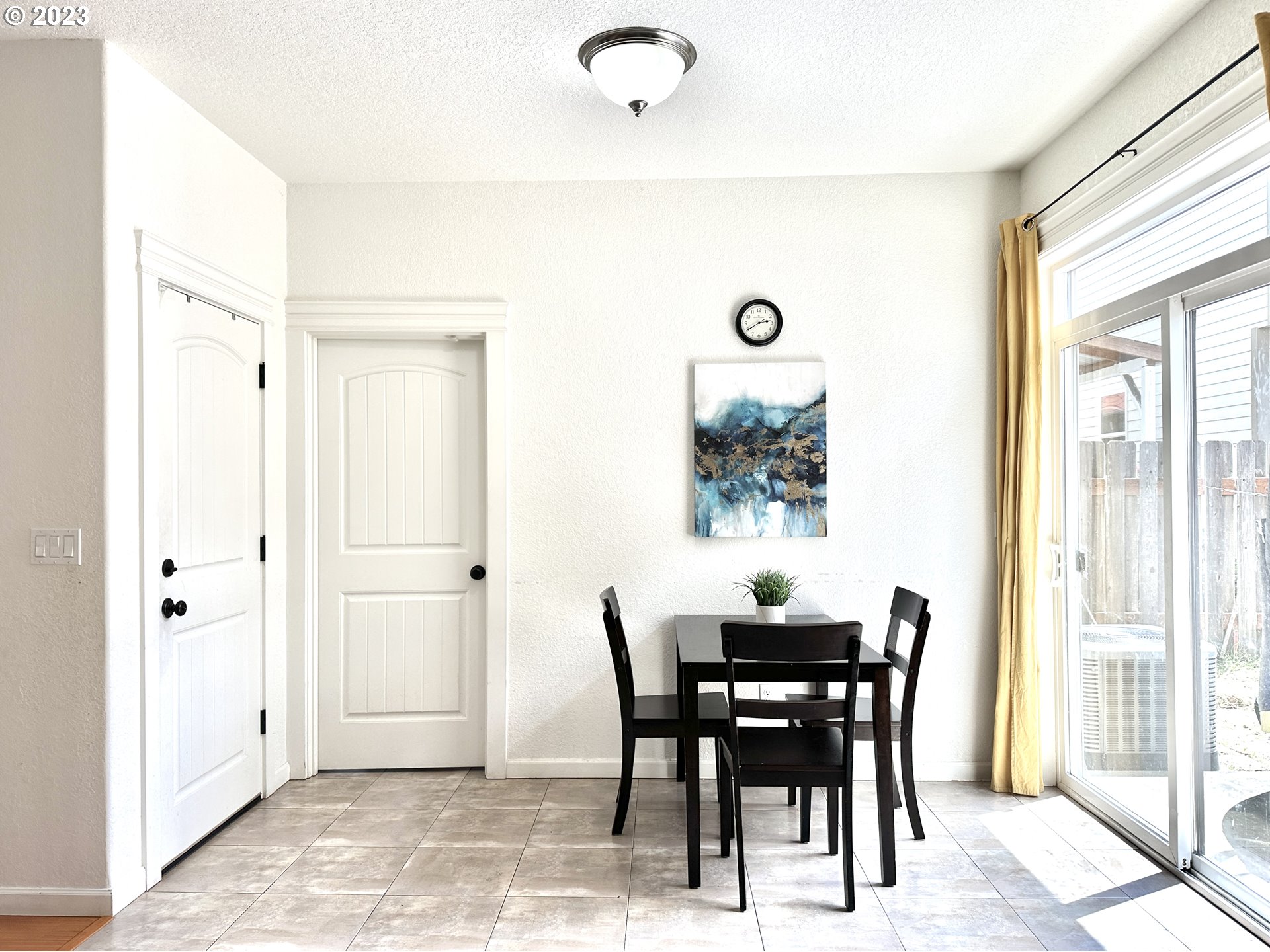 12428 Southeast Center Street Portland, OR 97236 - Photo 7 of 17 a view of a dining room with furniture and a potted plant