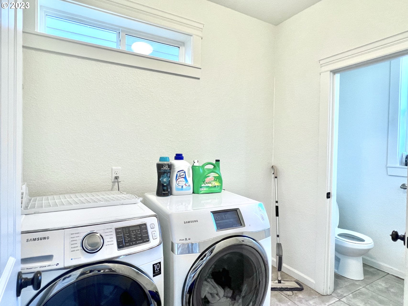 12428 Southeast Center Street Portland, OR 97236 - Photo 8 of 17 a utility room with dryer and washer