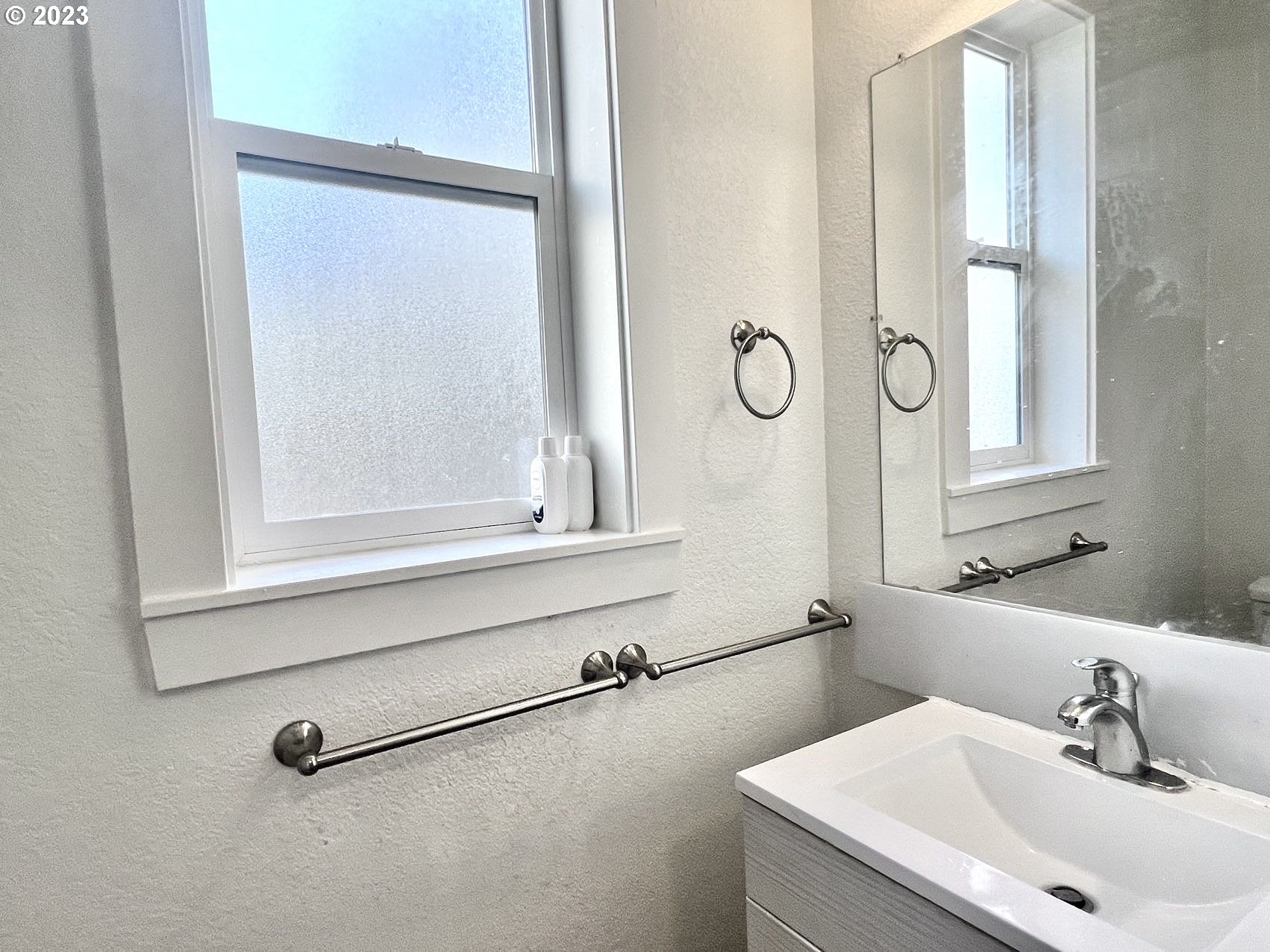 12428 Southeast Center Street Portland, OR 97236 - Photo 9 of 17 a bathroom with a sink and a mirror