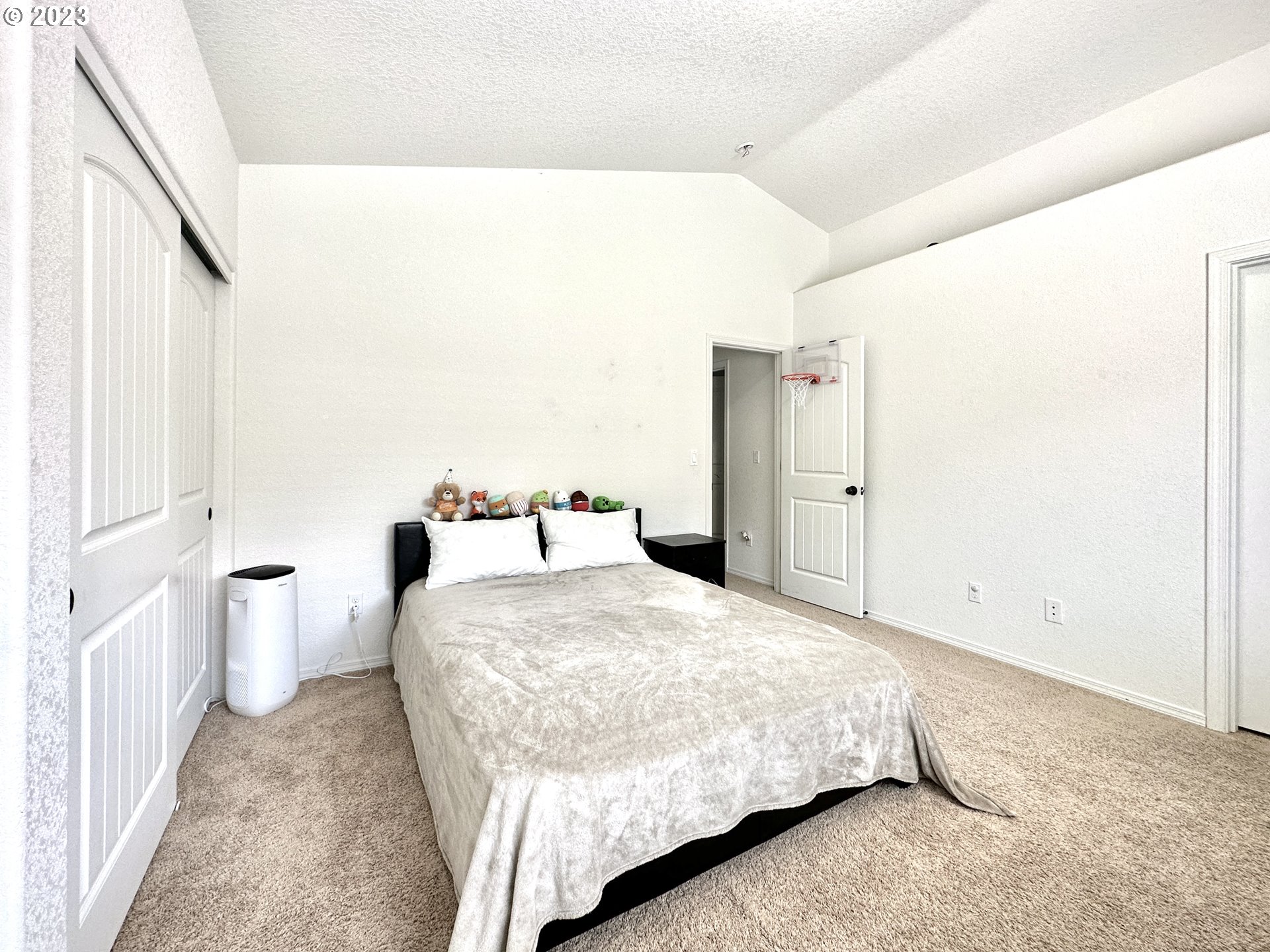 12428 Southeast Center Street Portland, OR 97236 - Photo 10 of 17 a bedroom with a bed and a cabinets