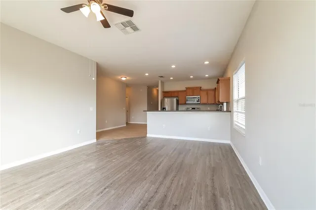 a view of a kitchen with a sink and a refrigerator