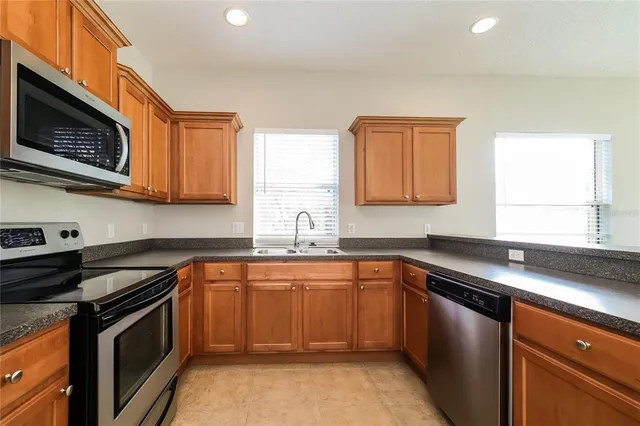 a kitchen with a sink stove and microwave