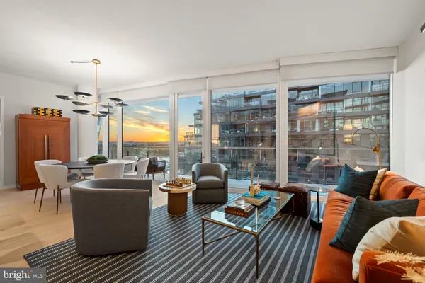 a living room with furniture and a floor to ceiling window