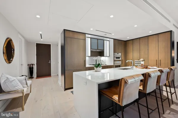 a kitchen with a table chairs sink and cabinets