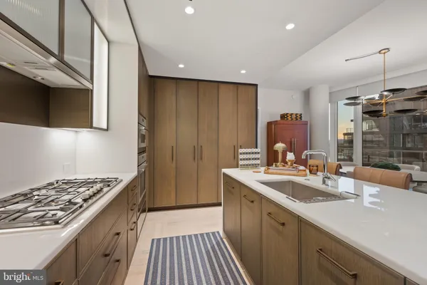 a kitchen with a sink stove and cabinets