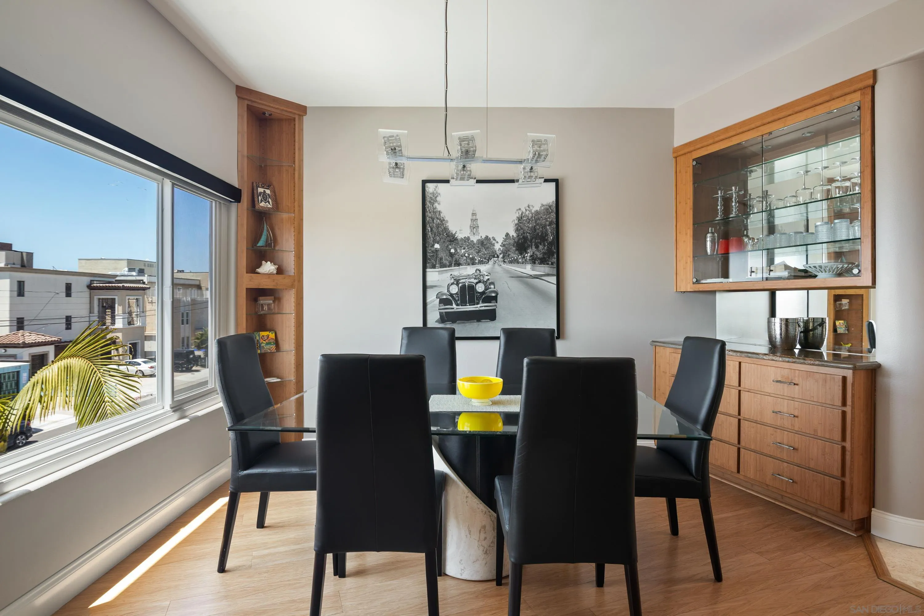 3701 Riviera Drive, Unit 11 Pacific Beach, CA 92109 - Photo 13 of 32 a dining room with furniture a window and wooden floor