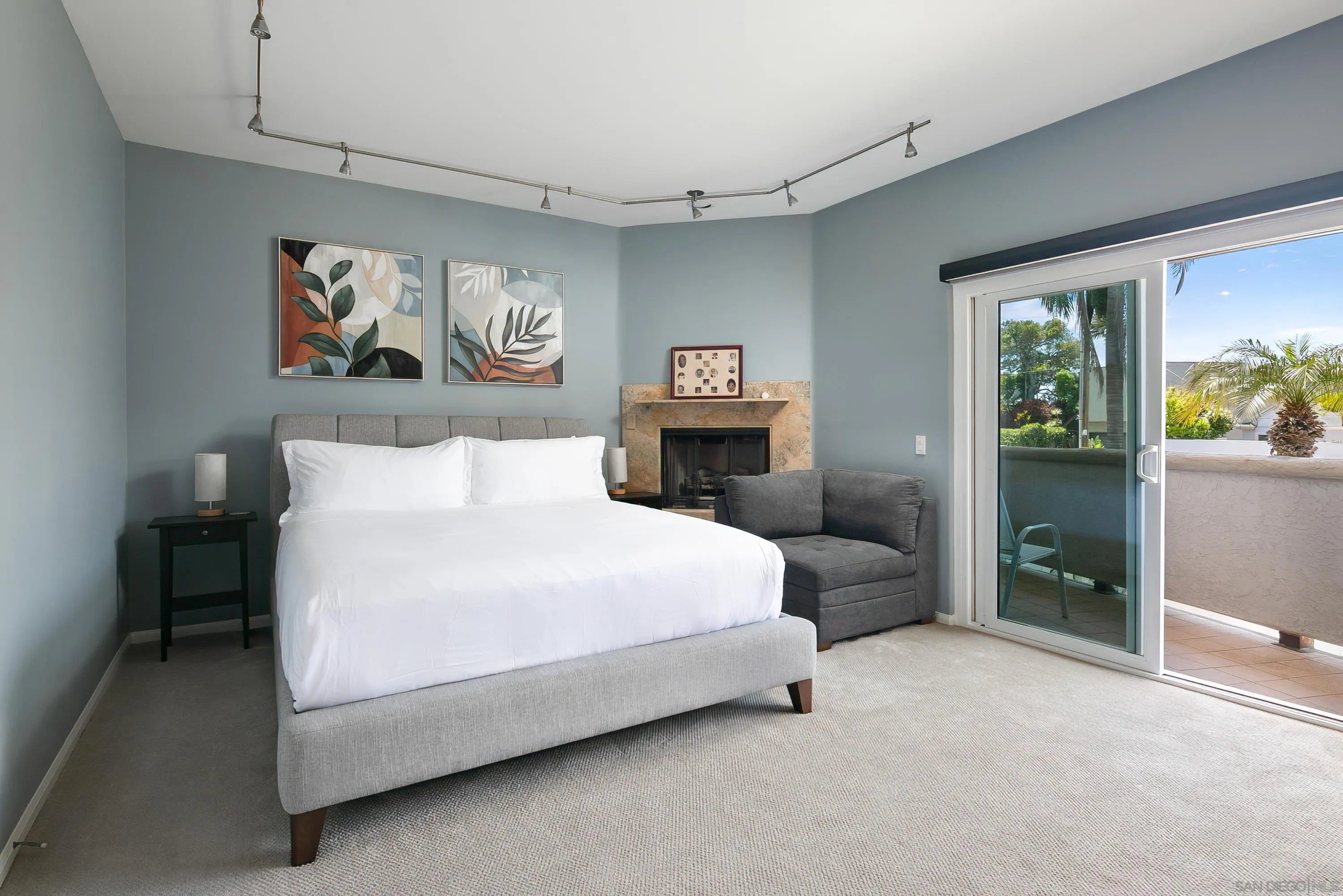 3701 Riviera Drive, Unit 11 Pacific Beach, CA 92109 - Photo 17 of 32 a spacious bedroom with a bed and a painting on the wall