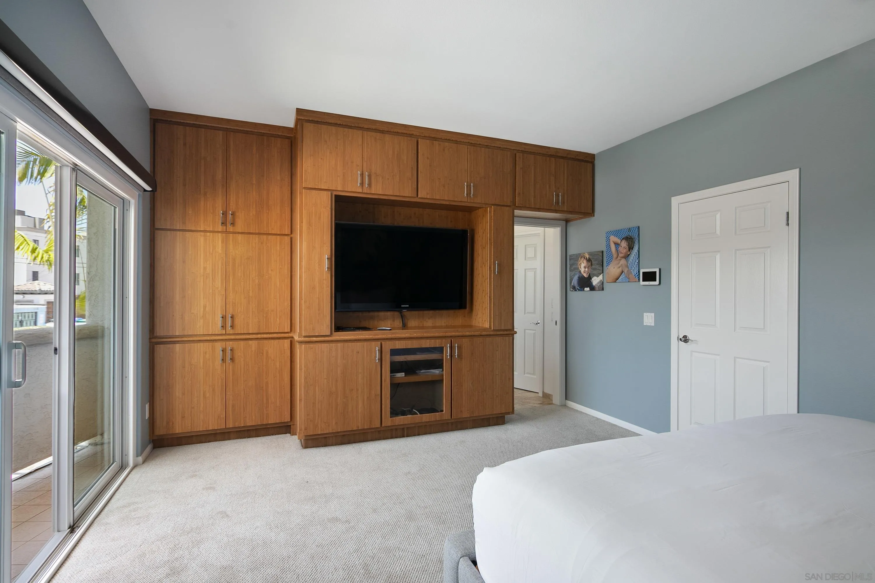 3701 Riviera Drive, Unit 11 Pacific Beach, CA 92109 - Photo 18 of 32 a bedroom with a bed and a flat screen tv