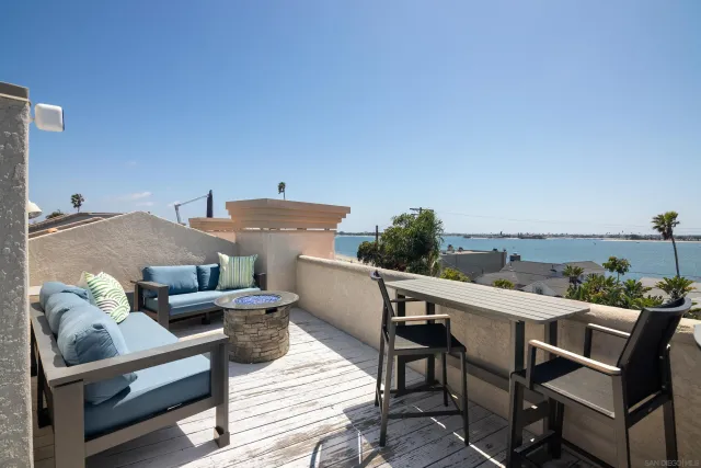 a terrace with outdoor seating and trees