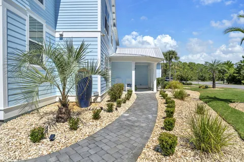 a living room with furniture kitchen and a chandelier