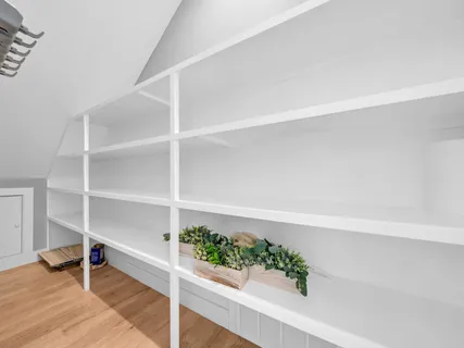 a view of walk in closet with empty racks