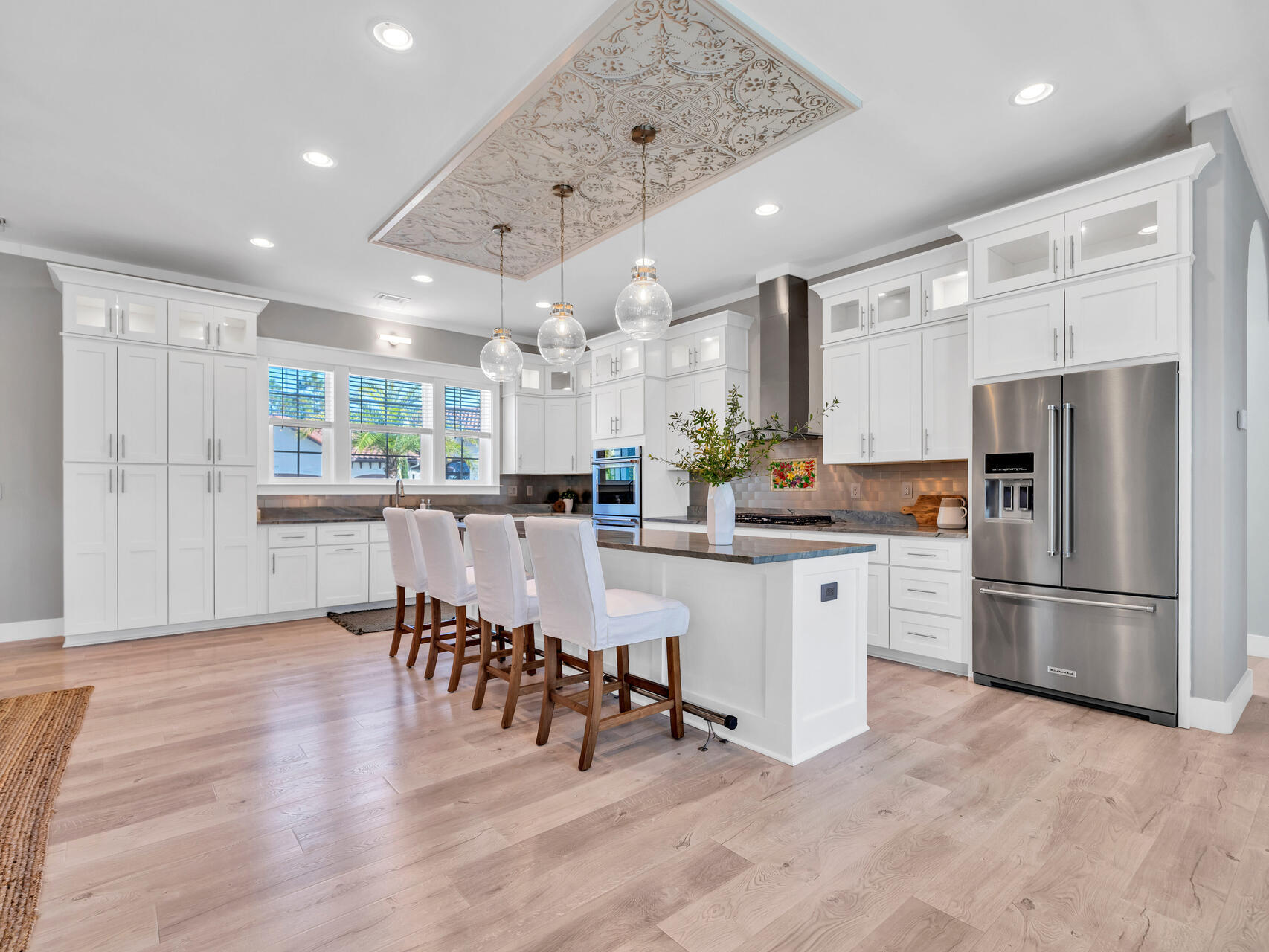 61 Sweet Breeze Drive Santa Rosa Beach, FL 32459 - Photo 6 of 92 a kitchen with stainless steel appliances kitchen island granite countertop a refrigerator and a stove top oven