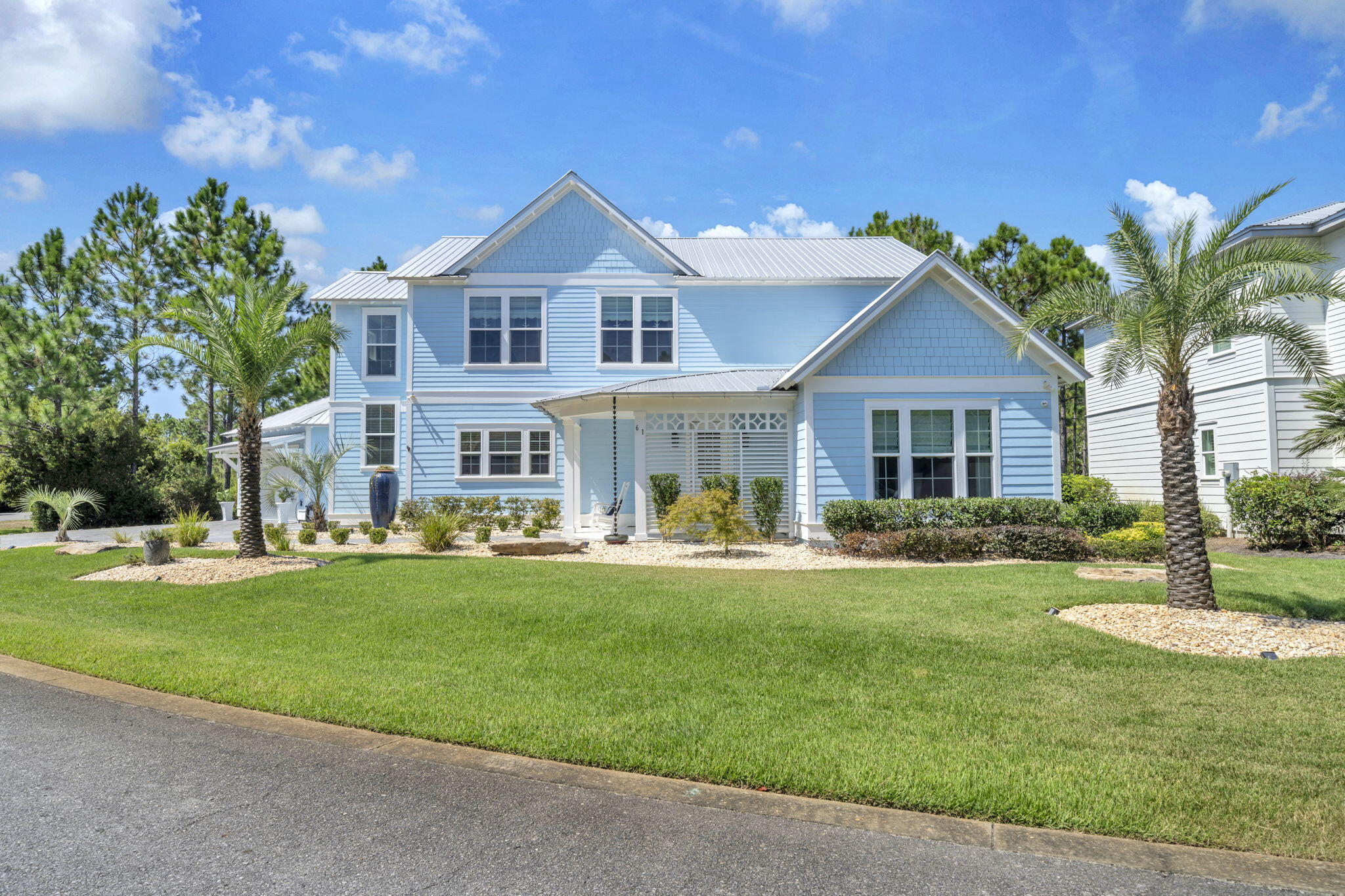 61 Sweet Breeze Drive Santa Rosa Beach, FL 32459 - Photo 83 of 92 a front view of a house with a garden and trees