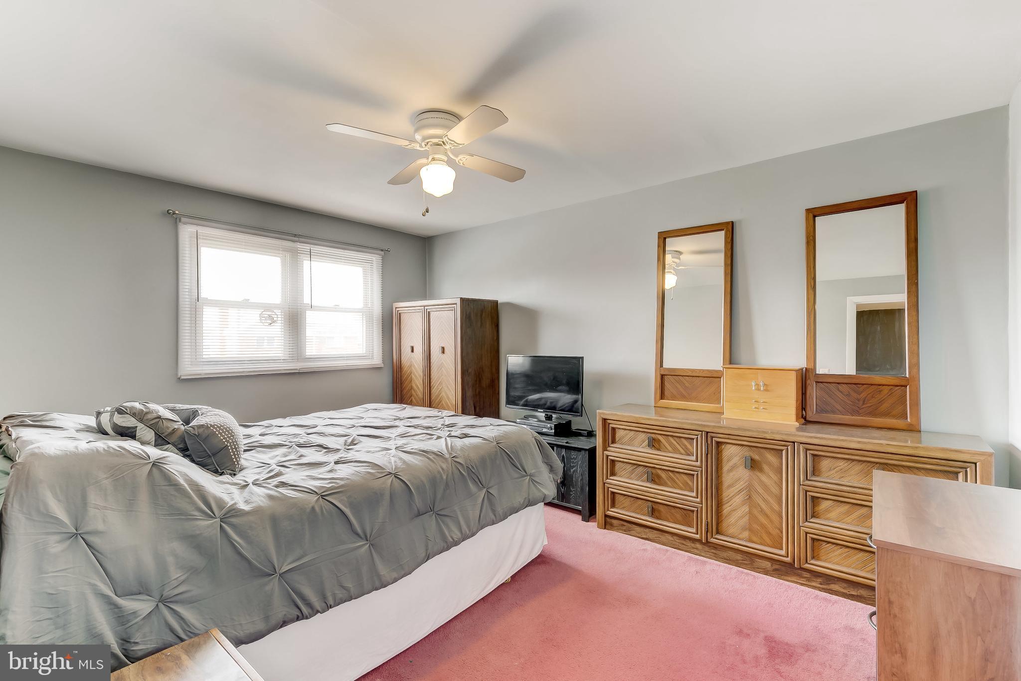7872 Kavanagh Road Baltimore, MD 21222 - Photo 22 of 39 a bedroom with a bed dresser and a window