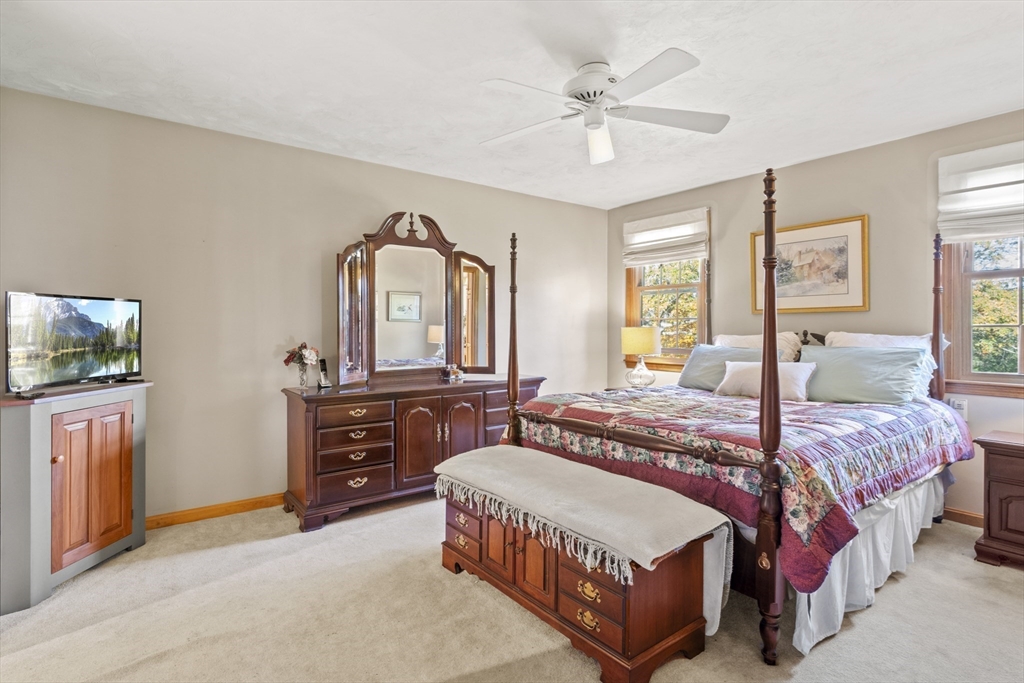 562 South Street Shrewsbury, MA 01545 - Photo 19 of 40 a spacious bedroom with a bed a chandelier and dresser