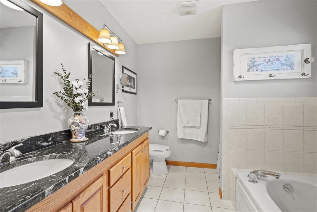 562 South Street Shrewsbury, MA 01545 - Photo 22 of 40 a spacious bathroom with a granite countertop sink and a mirror