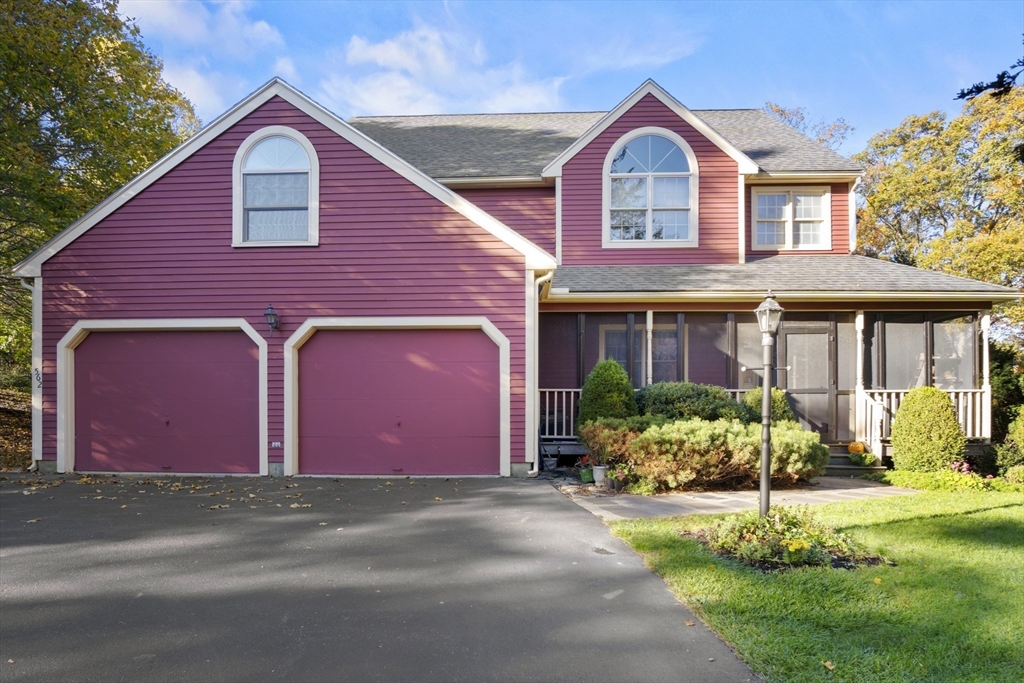 562 South Street Shrewsbury, MA 01545 - Photo 4 of 40 a front view of a house with a yard and garage