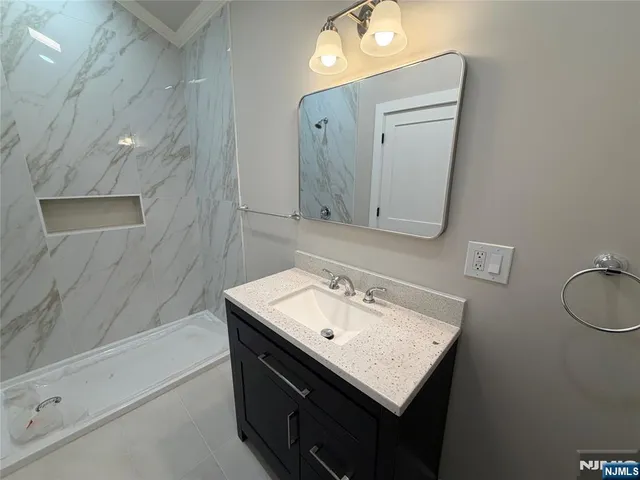 a bathroom with a toilet sink vanity and mirror