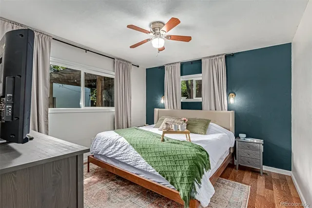 a bedroom with a bed and a large window