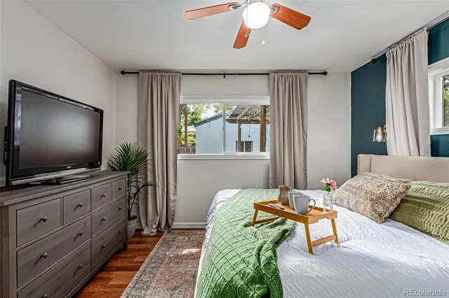a bedroom with furniture and a flat screen tv