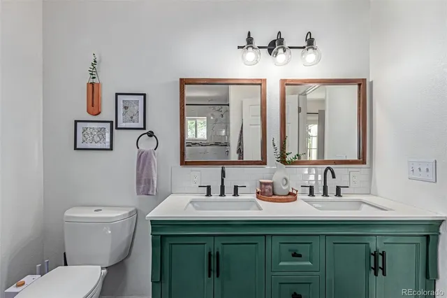 a bathroom with a toilet sink and mirror