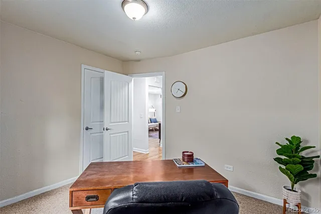a room with a table and potted plant