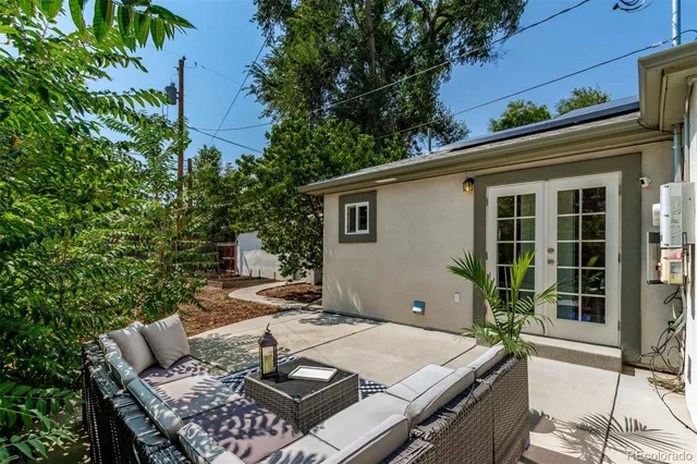 a view of a patio with table and chairs and potted plants