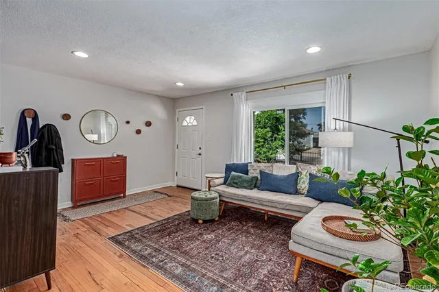 a living room with furniture and a rug