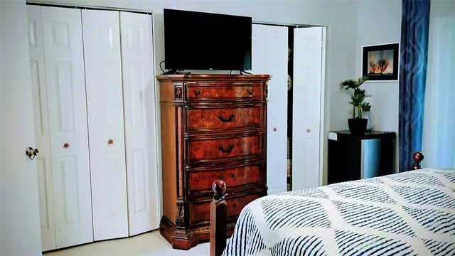 a bedroom with bed and a chandelier