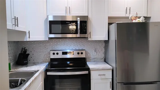 a kitchen with a stove and a microwave