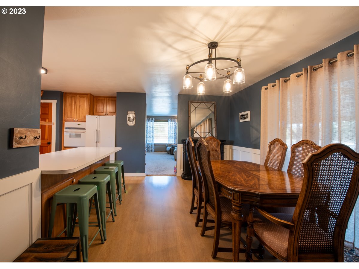 5279 Jasper Road Springfield, OR 97478 - Photo 12 of 48 a view of a dining room with furniture and wooden floor