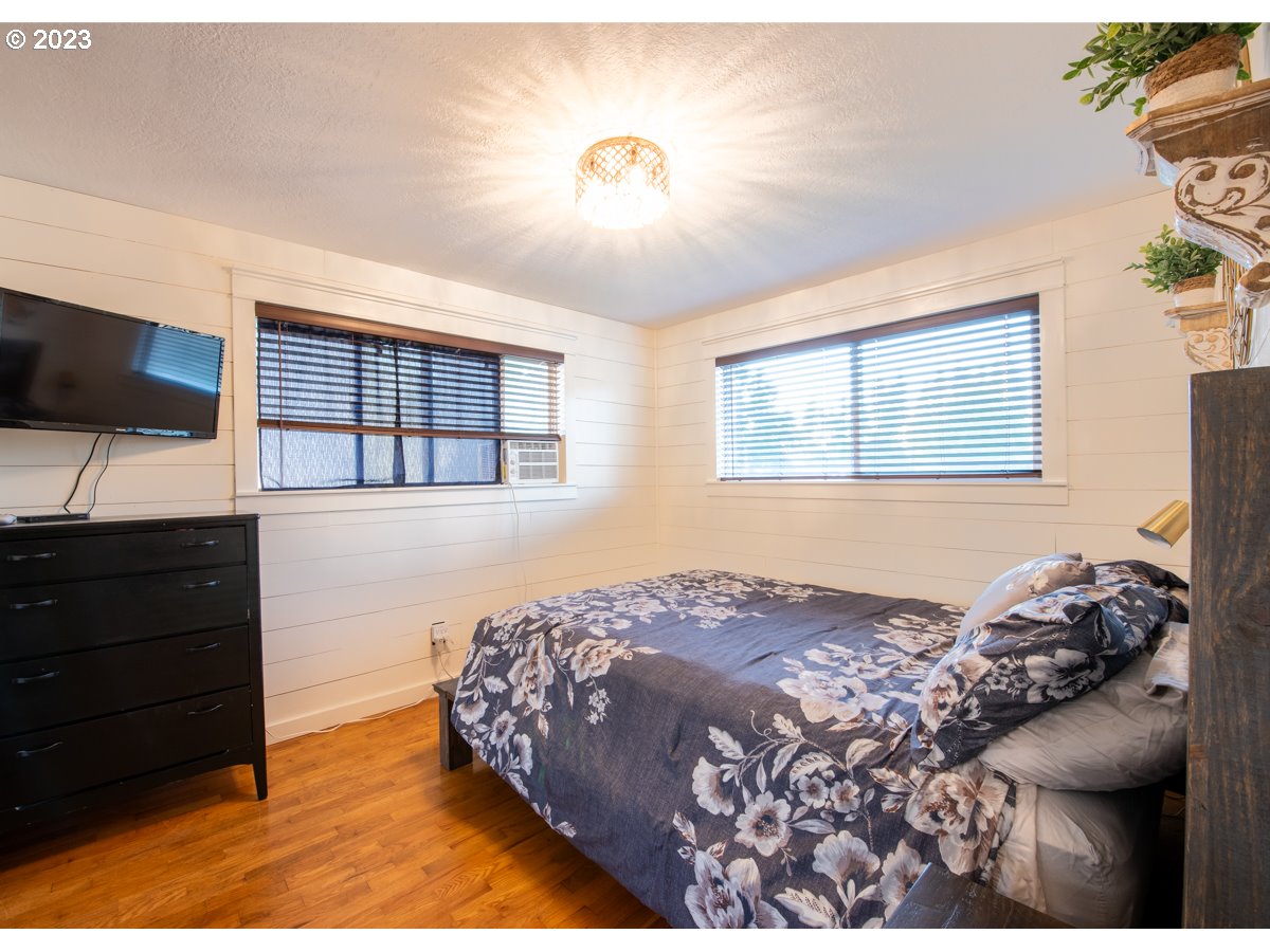 5279 Jasper Road Springfield, OR 97478 - Photo 20 of 48 a bedroom with a bed and a flat screen tv