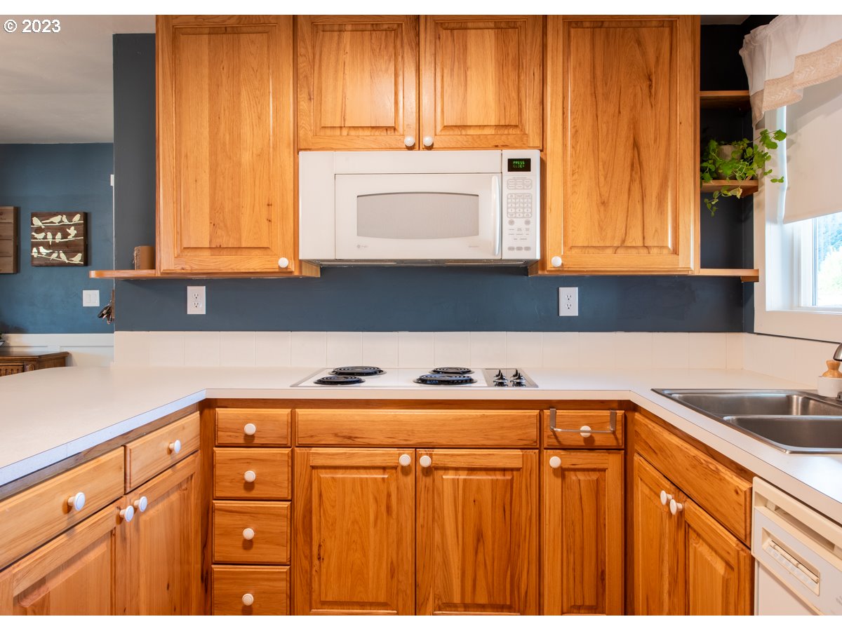 5279 Jasper Road Springfield, OR 97478 - Photo 9 of 48 a kitchen with granite countertop cabinets and a sink